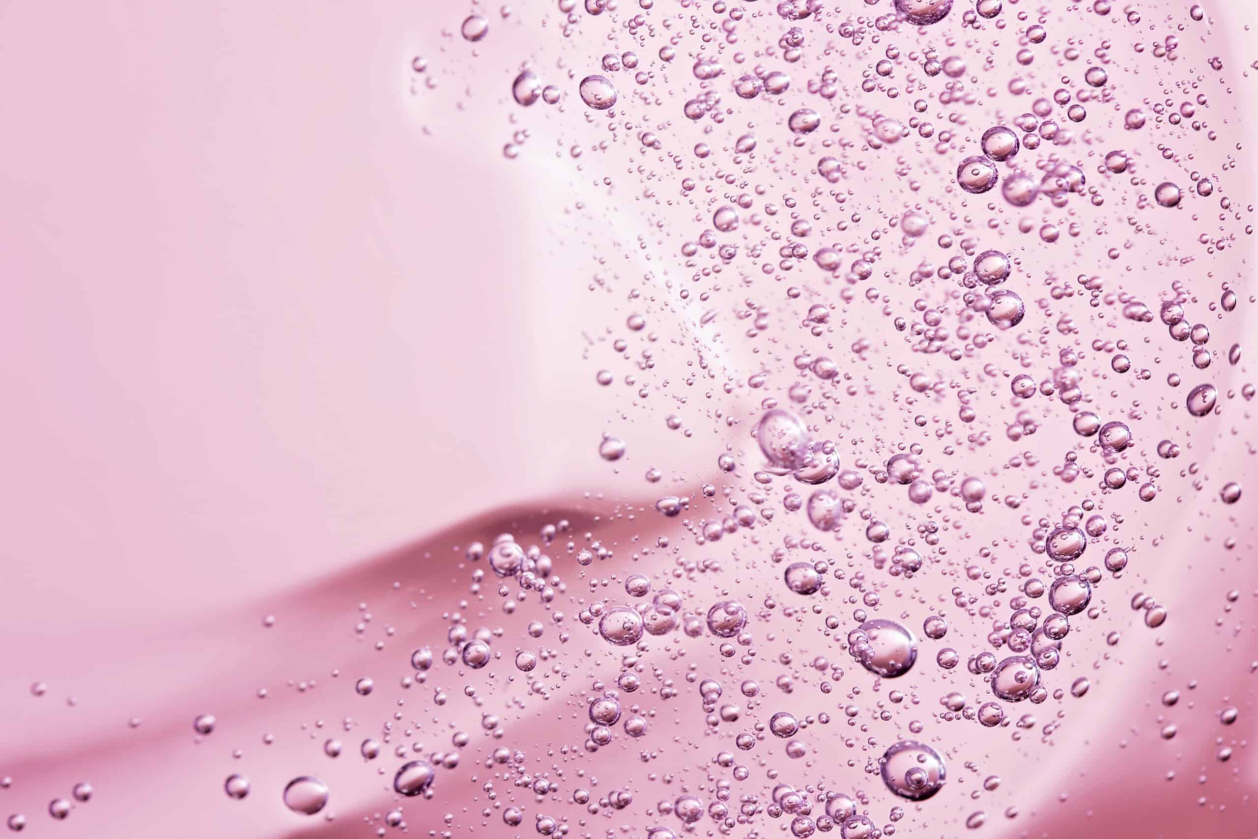 Close up macro Aloe vera gel cosmetic texture pink background. Lemongrass gel skincare product. antibacterial liquid with aloe vera, moisturizing. Safe and environmental friendly. Cruelty free